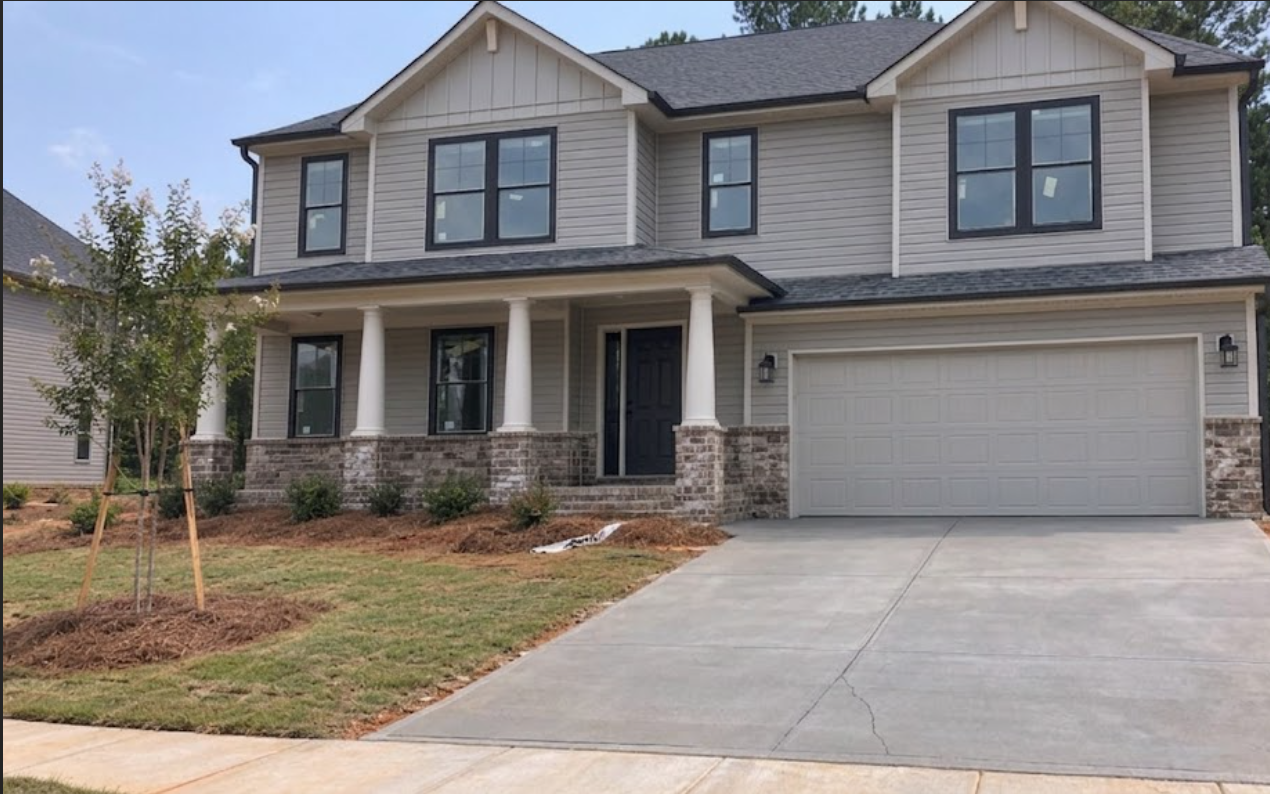 Same newly built home with siding, windows, and driveway clean and move-in ready after post-construction clean up