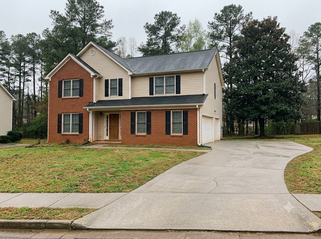 Same home and driveway returned to clean, even-toned concrete after red clay removal